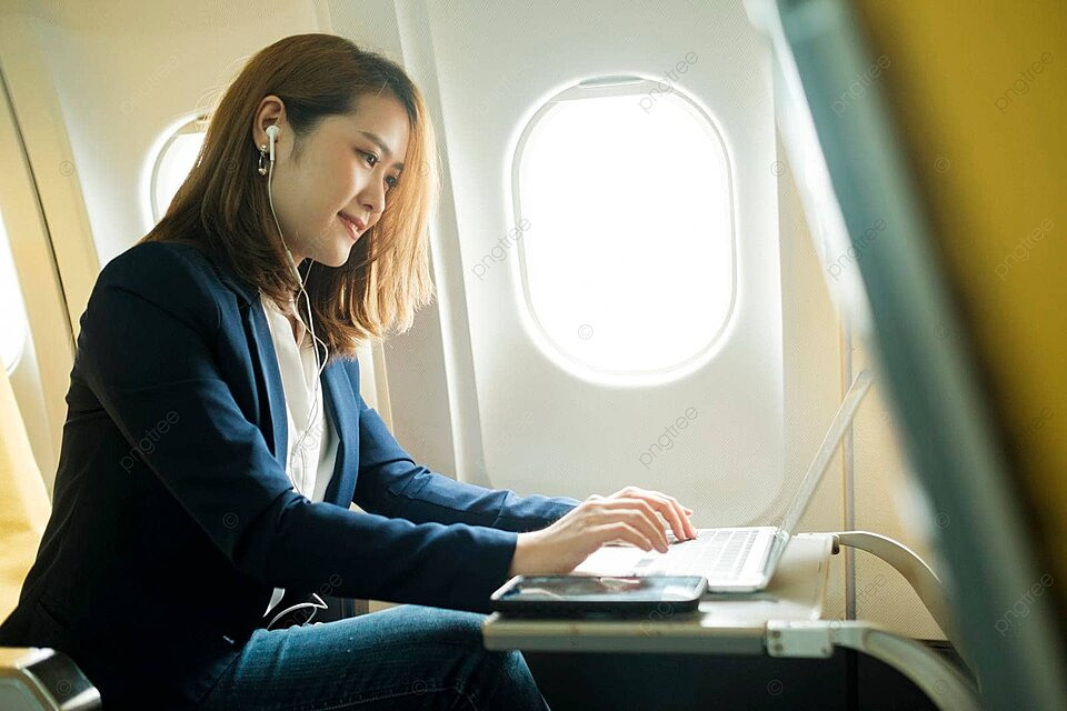 Person using a laptop during a flight
